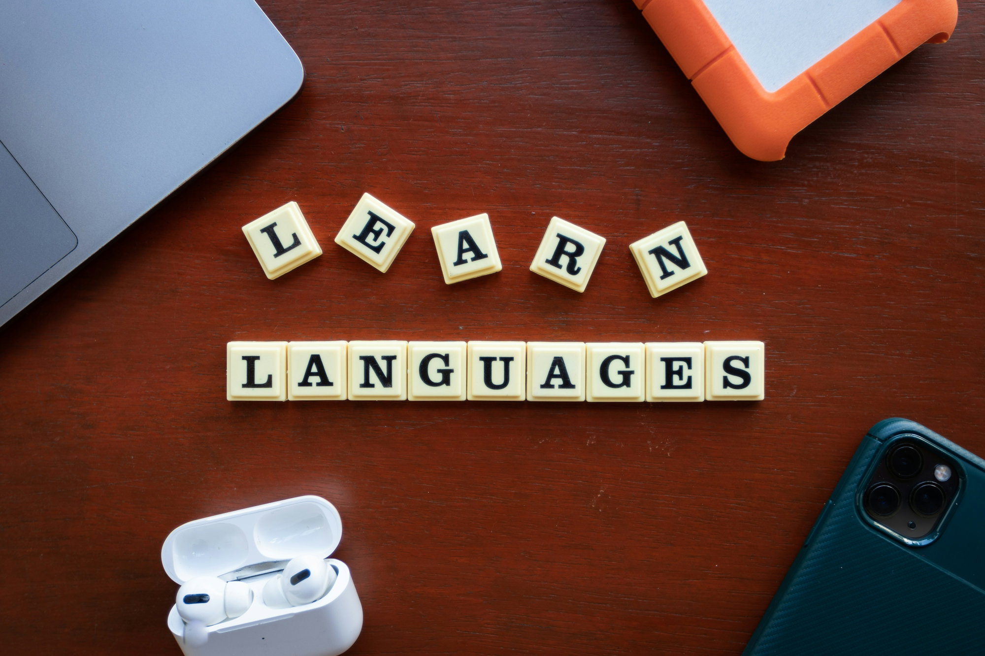 the word learn languages spelled out of scrabble tiles